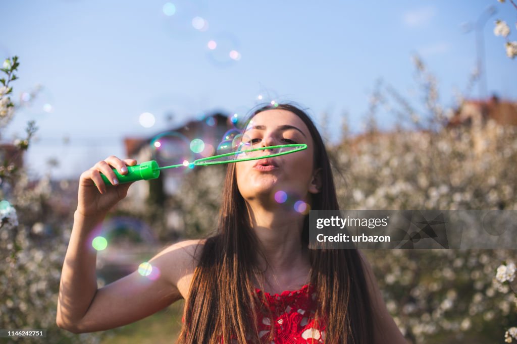 Blowing bubbles among blooming trees