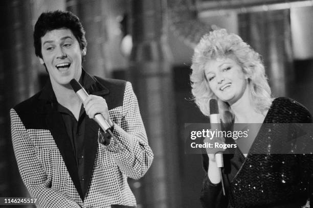 Welsh singers Shakin' Stevens and Bonnie Tyler performing at the Channel 4 Christmas Show, UK, 12th December 1983.