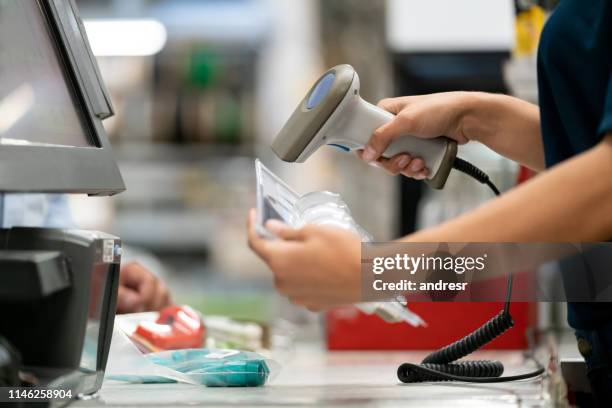 close-up on a cashier scanning products at a hardware store - scanner stock stock pictures, royalty-free photos & images