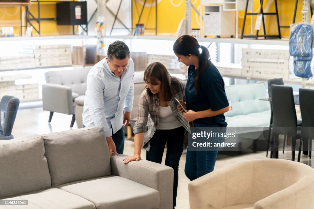 Couple buying a couch at a home improvement store