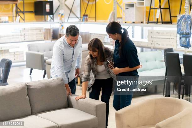 couple buying a couch at a home improvement store - buying furniture stock pictures, royalty-free photos & images