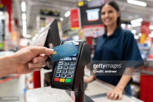 customer making a smart payment at the hardware store - contactless payment stock pictures, royalty-free photos & images