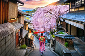 Woman wearing japanese traditional kimono walking at Historic Higashiyama district in spring, Kyoto in Japan.