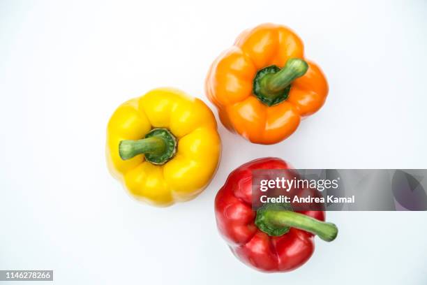 fresh yellow, orange and red bell pepper - bell peppers stock pictures, royalty-free photos & images