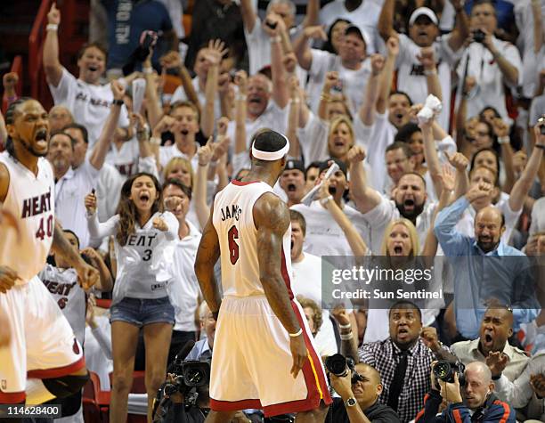 Miami Heat fans react to a dunk by LeBron James in the third quarter against the Chicago Bulls in Game 4 of the NBA's Eastern Conference finals at...