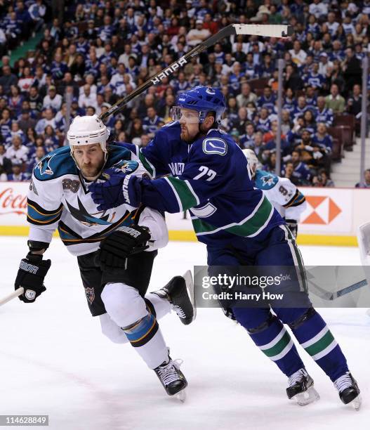 Ryane Clowe of the San Jose Sharks and Daniel Sedin of the Vancouver Canucks vie for position in the second period in Game Five of the Western...