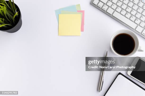 computer keyboard with coffee, smart phone, pot of plant and office supply on white background - looking down imagens e fotografias de stock