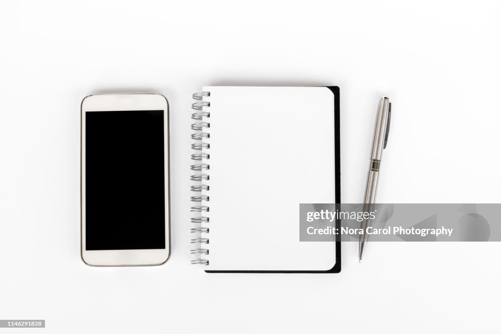 Top View of Smart Phone, Note Pad and Pen