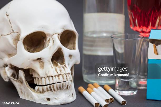 human skull and cigarette, alcohol. addiction kills - skull smoking a cigarette stock pictures, royalty-free photos & images