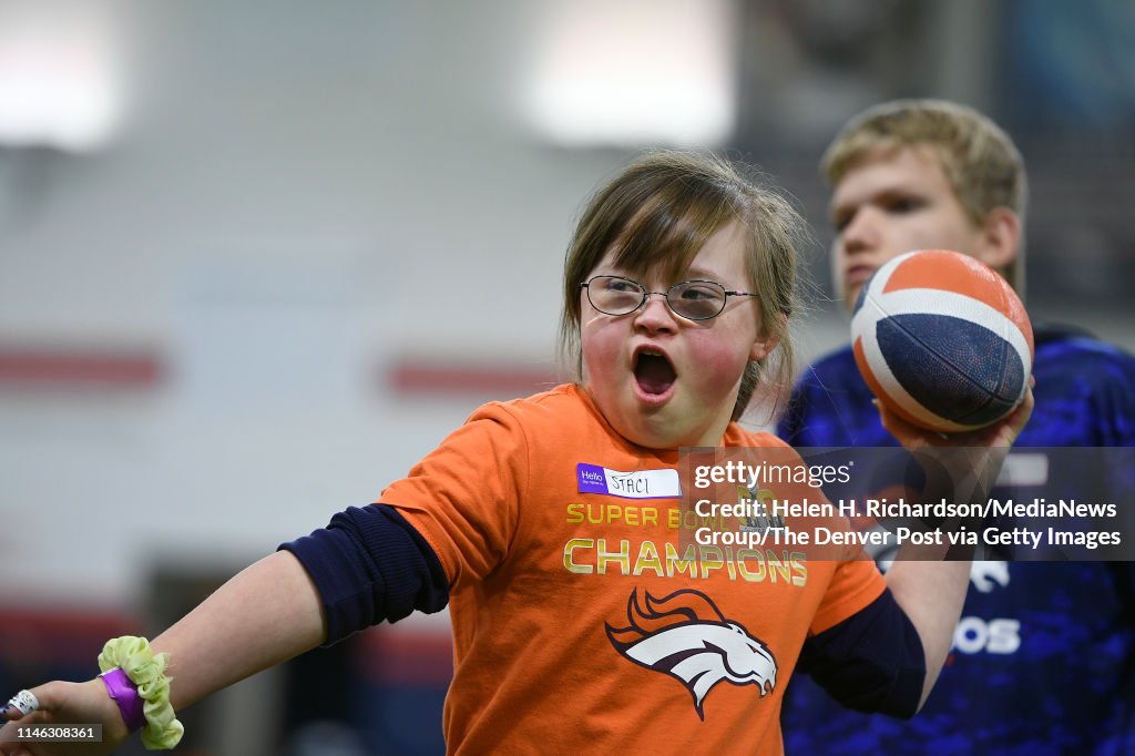 Denver Broncos play with kids with disabilities.