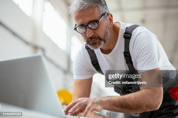 man. engineer. factory worker. male engineer working in factory. - empreiteiro de reparações imagens e fotografias de stock