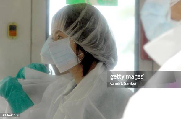 Minamisoma City residents, wearing radiation protective clothing, prepare for temporary return within the exclusion zone, 20km radius from the...