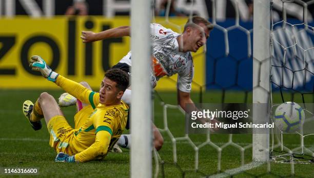 Carlos Augusto of Corinthians scores the opening goal against goalkeeper Tiepo of Chapecoense during a match between Corinthians and Chapecoense for...