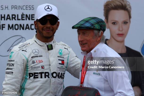 Lewis Hamilton of Mercedes AMG Petronas Motorsport celebrates in parc ferme with Jackie Stewart after qualifying for the F1 Grand Prix of Monaco.