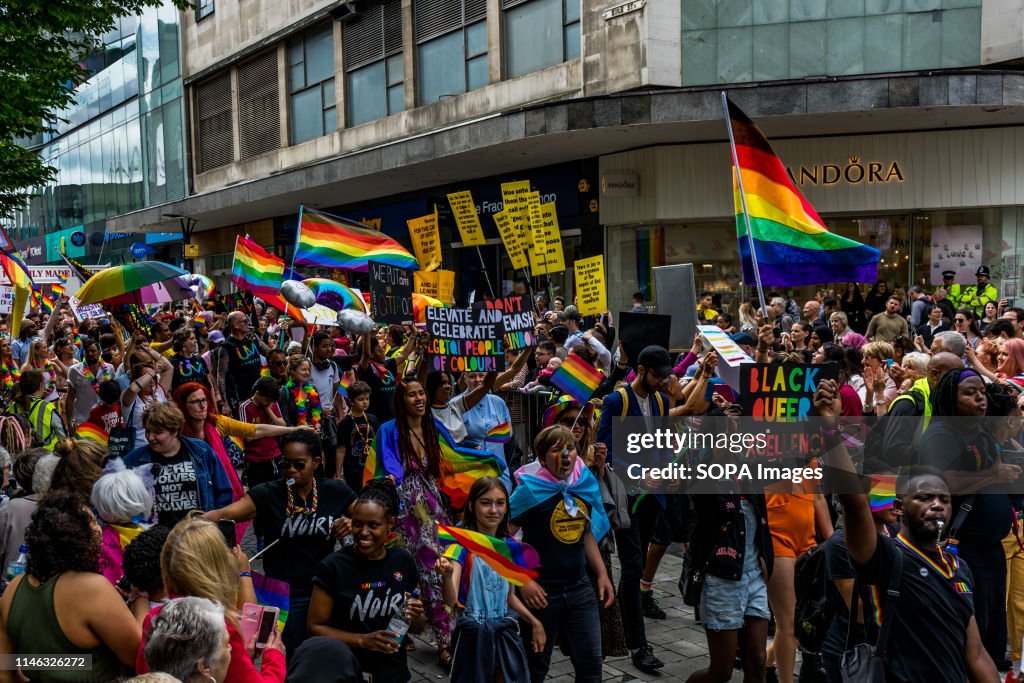 Members of the LGBTQ community are seen holding rainbow...