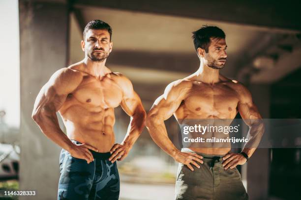 handsome muscular men. two bodybuilders. fashion model.  bodybuilders posing after workout. - handsome bodybuilders stock pictures, royalty-free photos & images