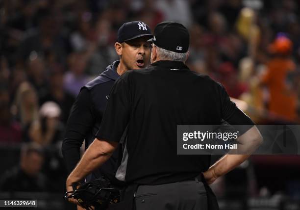 Manager Aaron Boone of the New York Yankees argues with home plate umpire Paul Emmel after being ejected during the seventh inning of a game against...