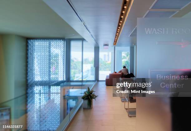 businessman working in office lounge - office bathroom stock-fotos und bilder