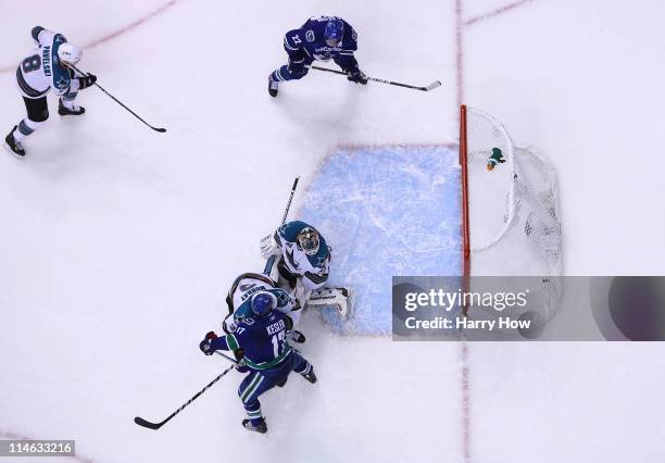 Goaltender Antti Niemi of the San Jose Sharks can't make the save on the deflection for a goal by Ryan Kesler of the Vancouver Canucks to send the...