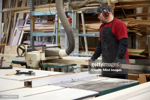 carpenter using saw in workshop - machine guarding stock pictures, royalty-free photos & images