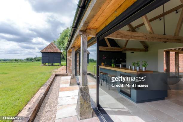 open-air kitchen and backyard in modern home - open country ストックフォトと画像