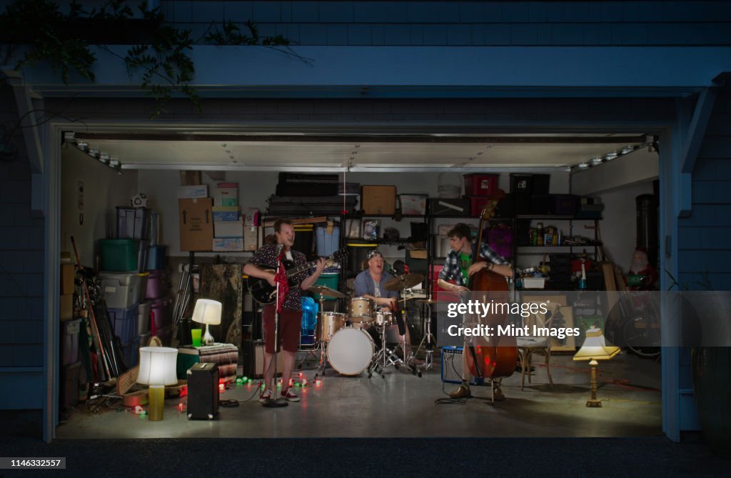 Caucasian band playing in garage