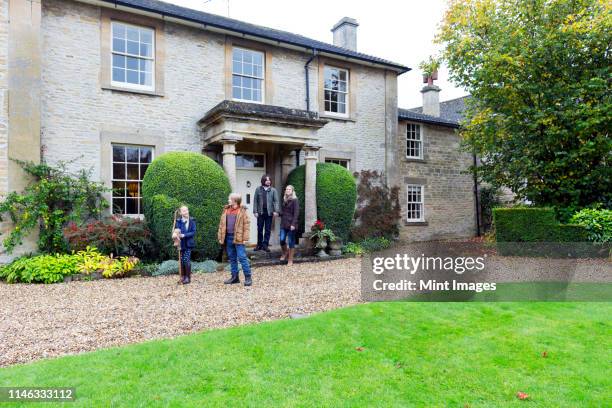 caucasian family standing near house - dadaism stock pictures, royalty-free photos & images