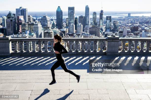 caucasian woman running in city - montréal stock pictures, royalty-free photos & images