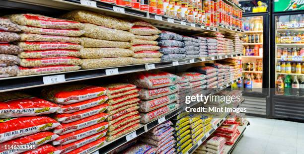 bags of food on shelves of grocery store - animal pouch stock pictures, royalty-free photos & images