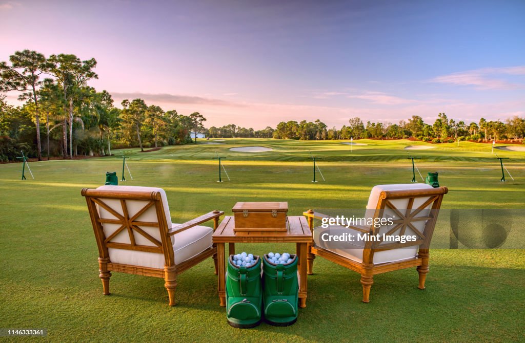 Chairs and golf balls on driving range