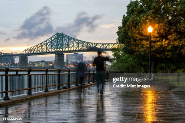 blurred view of people on montreal waterfront, quebec, canada - montreal city fotografías e imágenes de stock