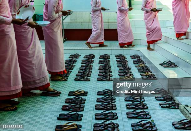 monks leaving sandals near staircase - cleric stock pictures, royalty-free photos & images