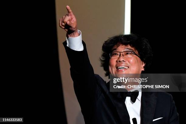 South Korean director Bong Joon-Ho reacts on stage after he was awarded with the Palme d'Or for the film "Parasite " on May 25, 2019 during the...