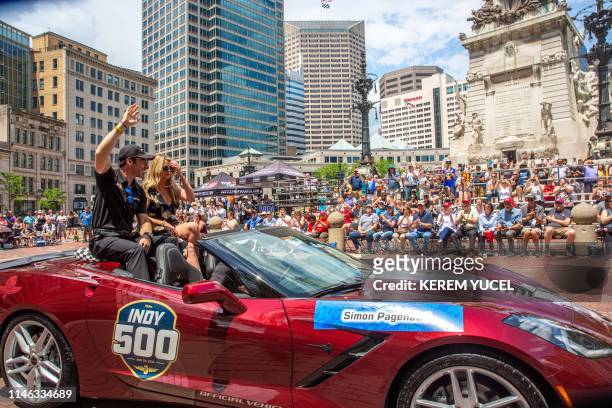Simon Pagenaud and girlfriend Hailey McDermott wave to the crowd during the 103rd Indy 500 Festival Parade on May 26, 2019 in Indianapolis, Indiana.
