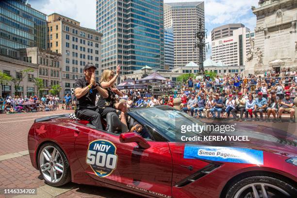 Simon Pagenaud and girlfriend Hailey McDermott wave to the crowd during the 103rd Indy 500 Festival Parade on May 26, 2019 in Indianapolis, Indiana.