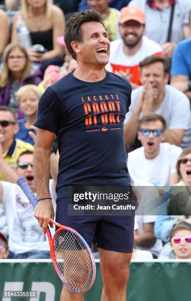 Fabrice Santoro - paired with French singer Vianney Bureau - in action against Chinese actor Jin Dong and Zhang Shuai of China during the final of...