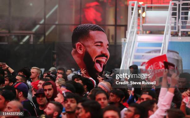 Toronto fans, some with signs and Drake cutouts, cheer in Jurassic Park as the Toronto Raptors play the Milwaukee Bucks in game six of the NBA...