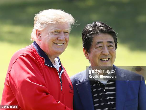 President Donald Trump, left, and Shinzo Abe, Japan's prime minister, pose for photographs at Mobara Country Club in Mobara, Chiba Prefecture, Japan,...