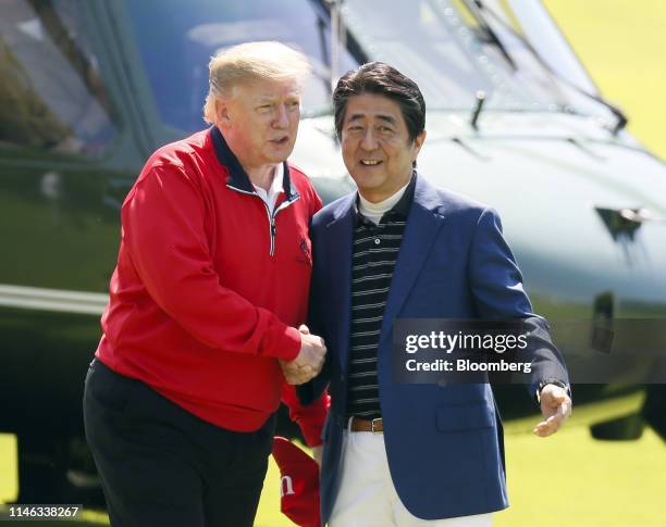 President Donald Trump, left, greets Shinzo Abe, Japan's prime minister, at Mobara Country Club in Mobara, Chiba Prefecture, Japan, on Sunday, May...