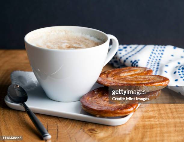 close up of palmier cookies and cup of coffee - seattle coffee stock pictures, royalty-free photos & images