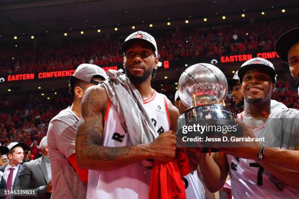 Kawhi Leonard of the Toronto Raptors and Kyle Lowry of the Toronto Raptors pose for a photo with the Eastern Conference Championship trophy after a...