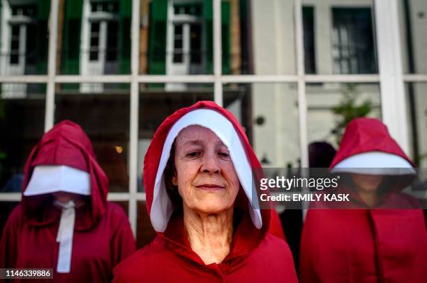 Protesters dressed as characters from the series "The Handmaid's Tale" march down the French Quarter of New Orleans, Louisiana, on May 25 to protest...