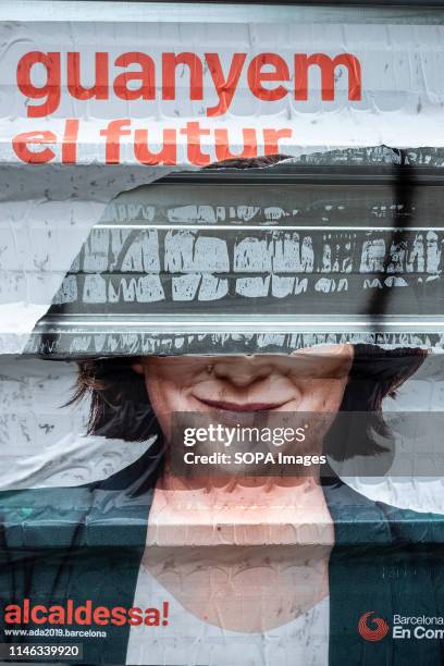 Torn electoral propaganda poster of the current mayor Ada Colau. Election posters are seen broken, manipulated or covered by other posters during the...