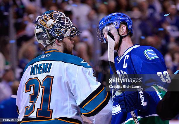 Captain Henrik Sedin of the Vancouver Canucks shakes hands with goaltender Antti Niemi of the San Jose Sharks after the Vancouver Canucks won Game...