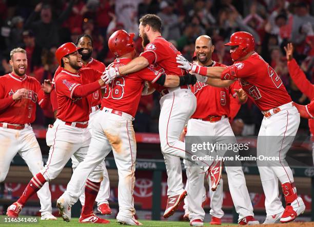 Jared Walsh celebrates after hitting a walk off pinch hit single in the ninth inning of the game to score Kole Calhoun of the Los Angeles Angels of...