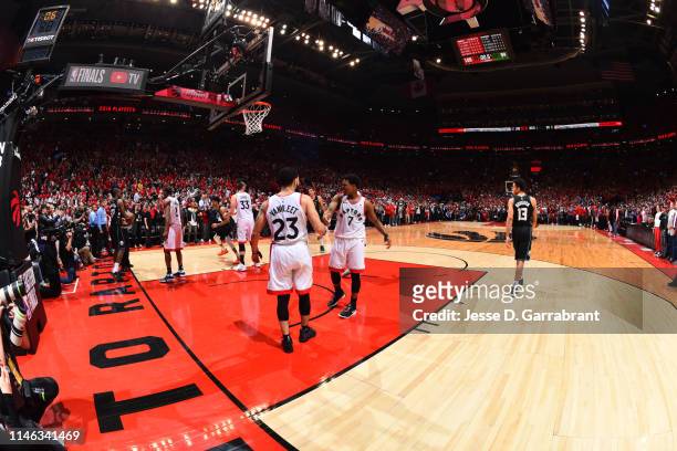 Fred VanVleet of the Toronto Raptors and Kyle Lowry of the Toronto Raptors high-five after a game against the Milwaukee Bucks during Game Six of the...