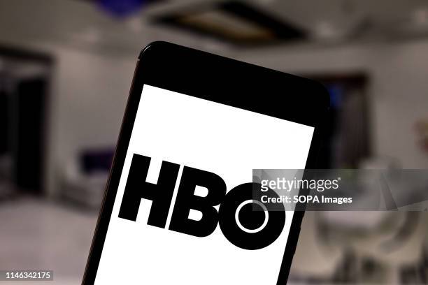 In this photo illustration the Home Box Office logo is seen displayed on a smartphone.