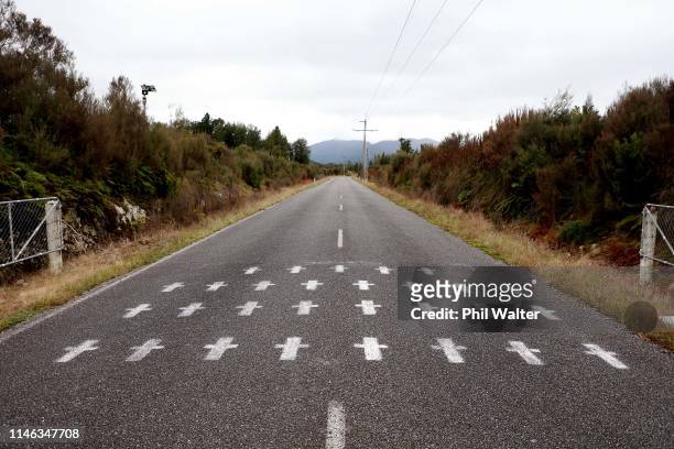 White crosses are painted on the access road to the Pike River Mine on May 02, 2019 in Greymouth, New Zealand. 29 men were trapped and killed...