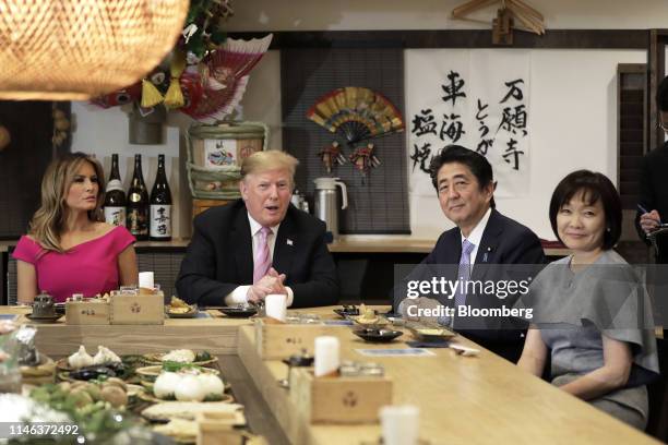 President Donald Trump, second left, speaks while sitting at a counter with First Lady Melania Trump, left, Shinzo Abe, Japan's prime minister,...