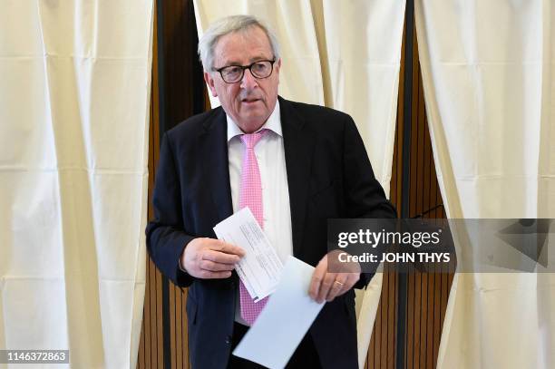 Jean-Claude Juncker, head of the European Commission prepares to cast his ballot at a polling station in Capellen, on May 26 as part of the vote for...